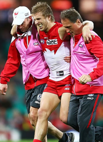 Kieran Jack leaves the field helped by Tim Needham and Nathan Gibbs