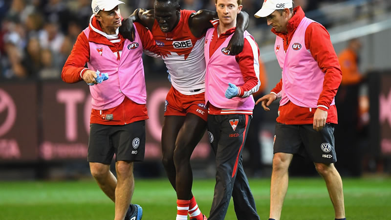 Sydney Swans defender Aliir Aliir goes a medial ligament in his knee - assisted by Tim Needham Sydney Swans defender Aliir Aliir goes a medial ligament in his knee - assisted by Tim Needham
